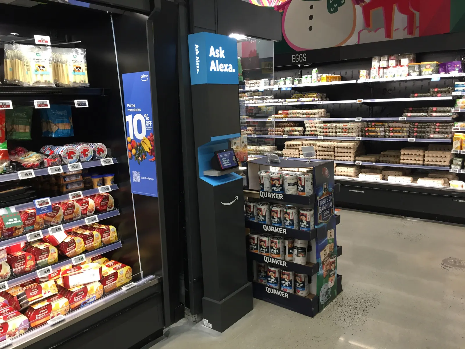 Kisok in supermarket with screen and sign that says "Ask Alexa"
