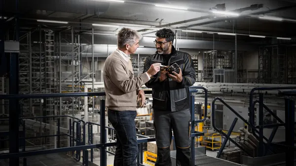 Two people talking in the warehouse