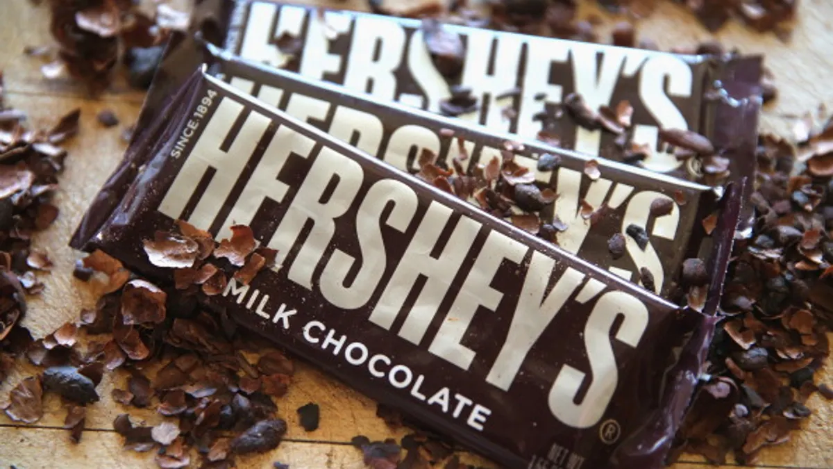 Photo of Hershey chocolate bars and flakes of chocolate beneath the packages
