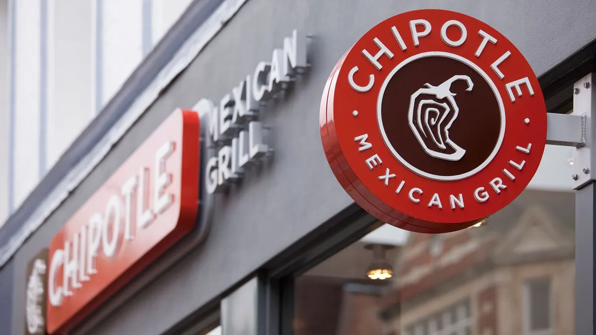 A close up image of a round red sign that says "Chipotle Mexican Grill."