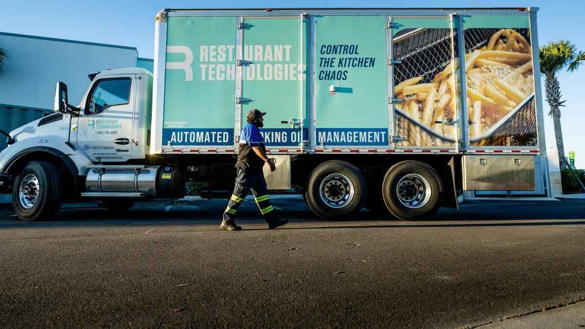 Driver walking by a truck